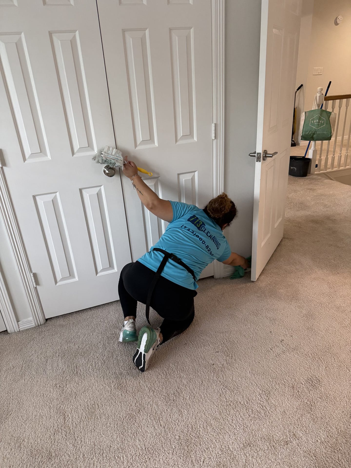 713 Cleaning team member dusting doors and wiping baseboards during a house cleaning in Houston, TX